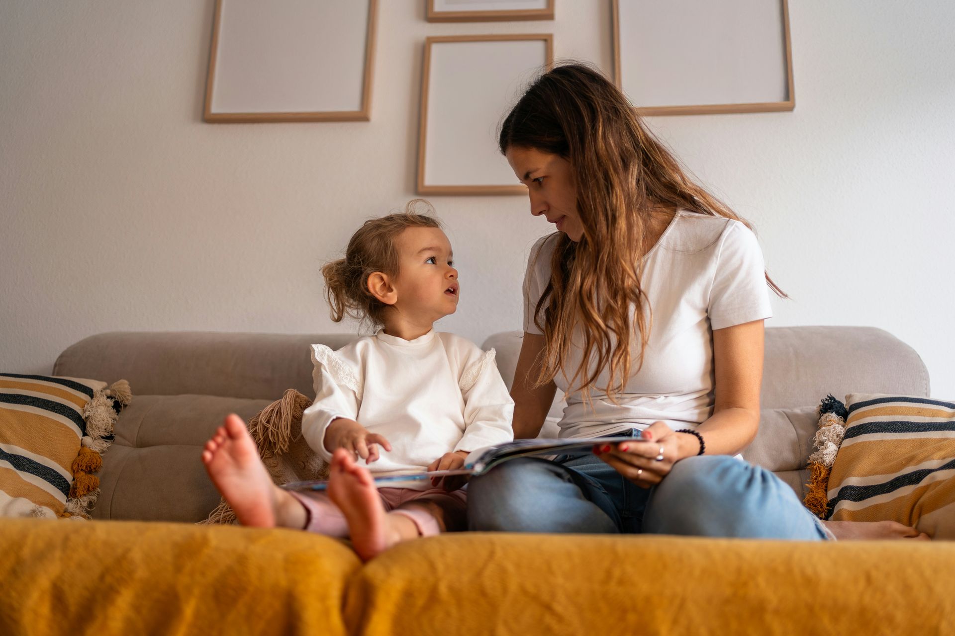 Patio with cream-colored awning overlooking water, furnished with seating and fire pit.