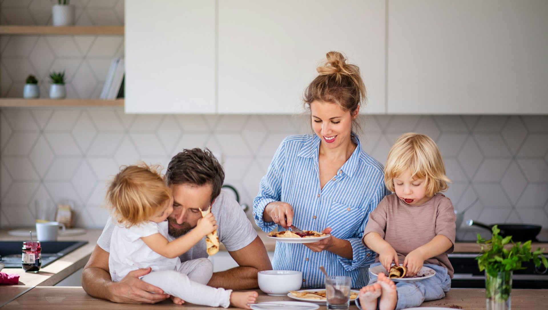 Patio with seating under a slatted pergola, overlooking a grassy backyard.