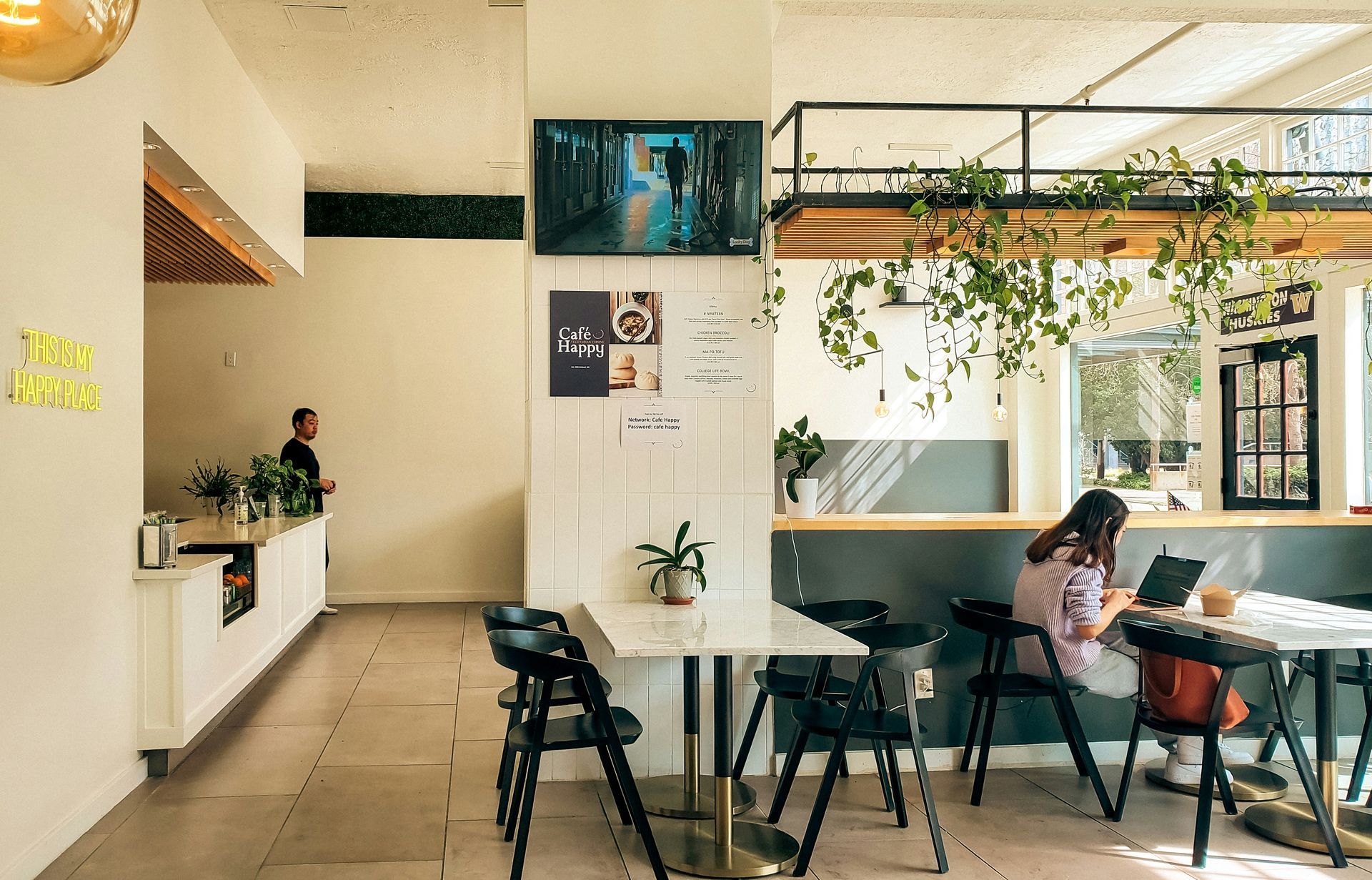 Patio with a retractable roof, seating area, dining table, and a playhouse in the backyard.