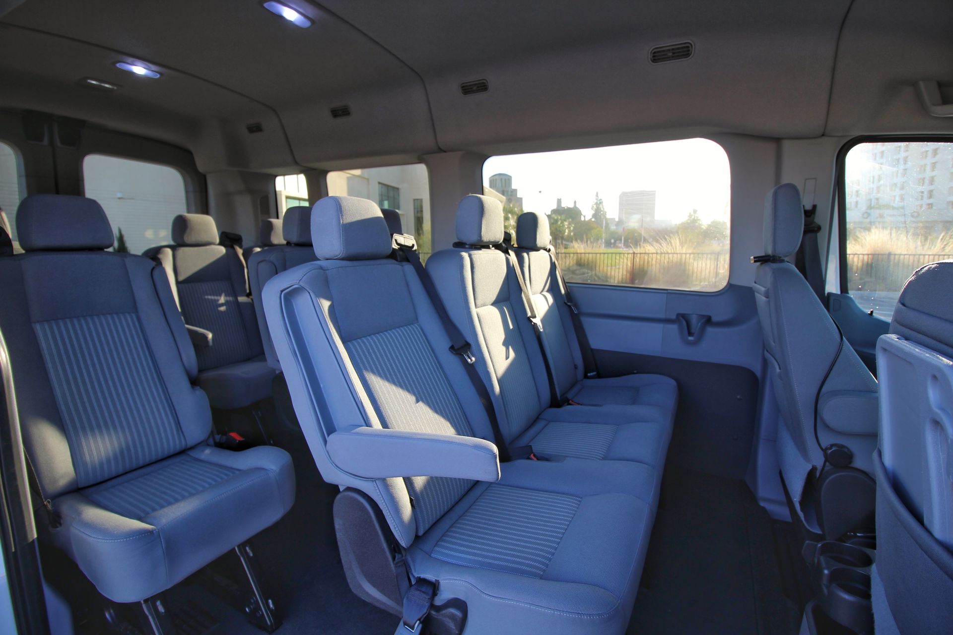 The inside of a van with a lot of seats and a window.