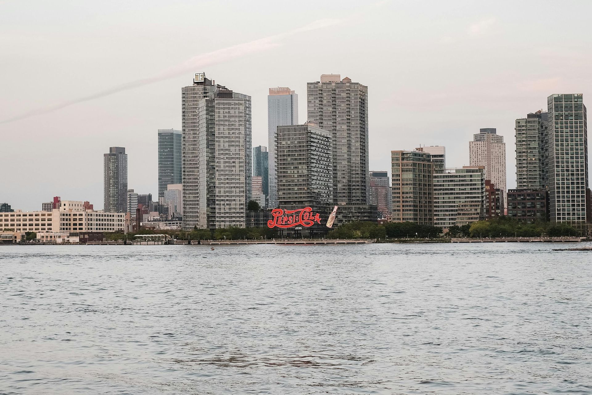 A city skyline is visible over a body of water.