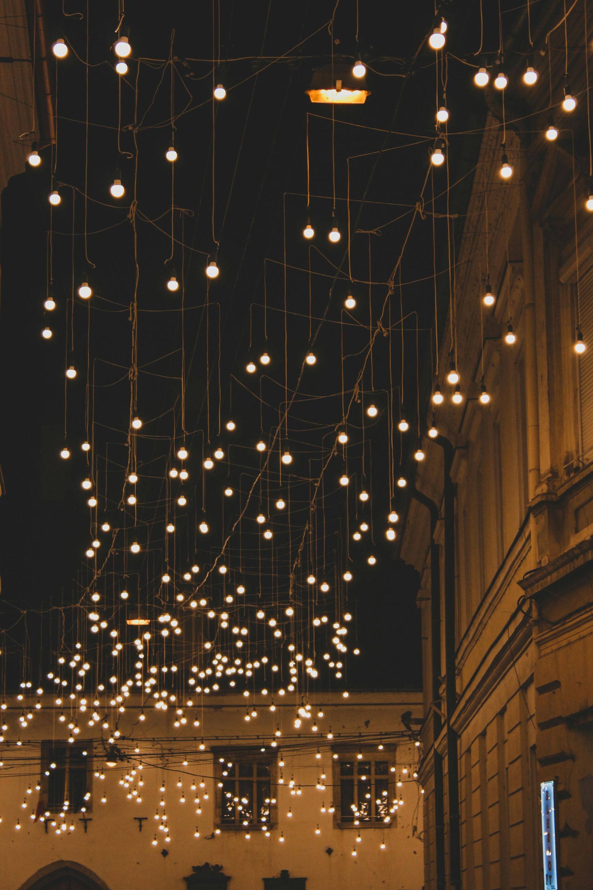 A bunch of lights are hanging from the ceiling of a building.