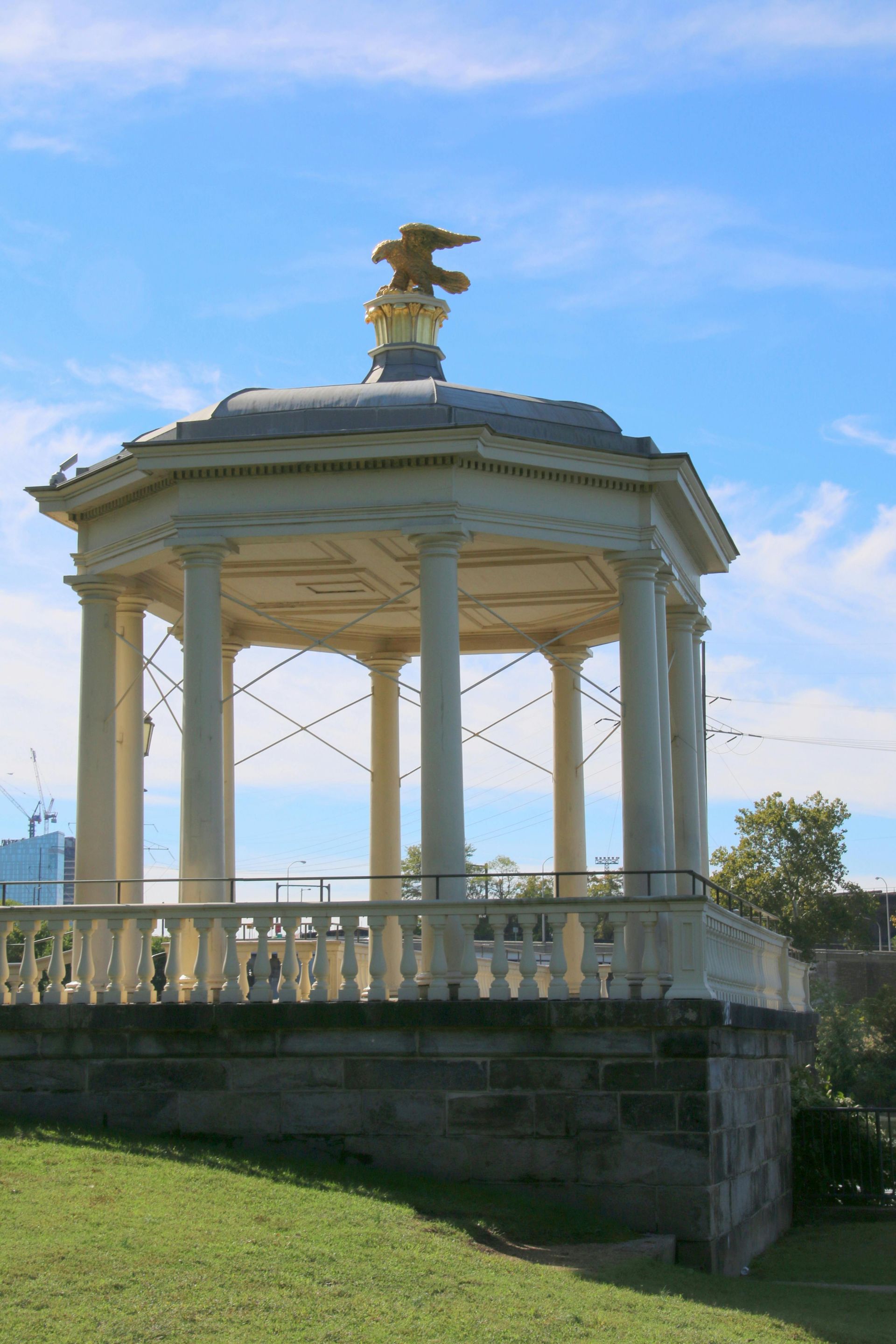 A gazebo with a statue of an eagle on top of it