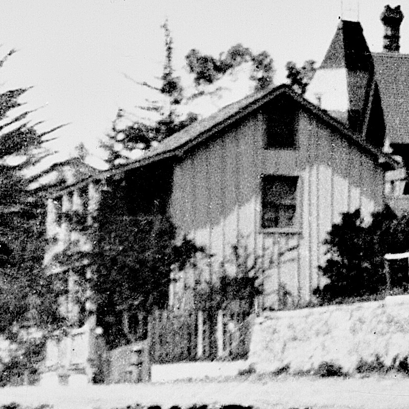 A black and white photo of a house with a chimney