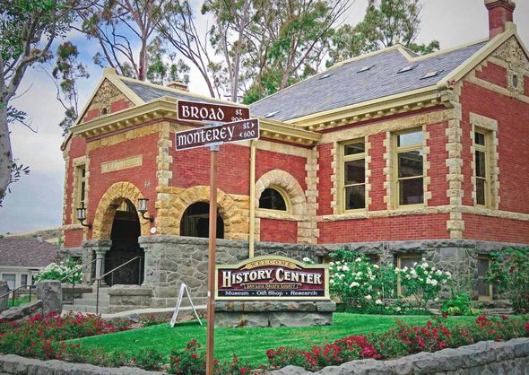 A brick building with a sign in front of it that says history center