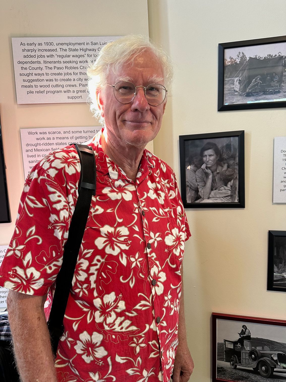 A woman is standing in front of a sign that says grassroots