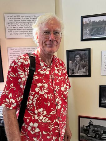 A woman is standing in front of a sign that says grassroots