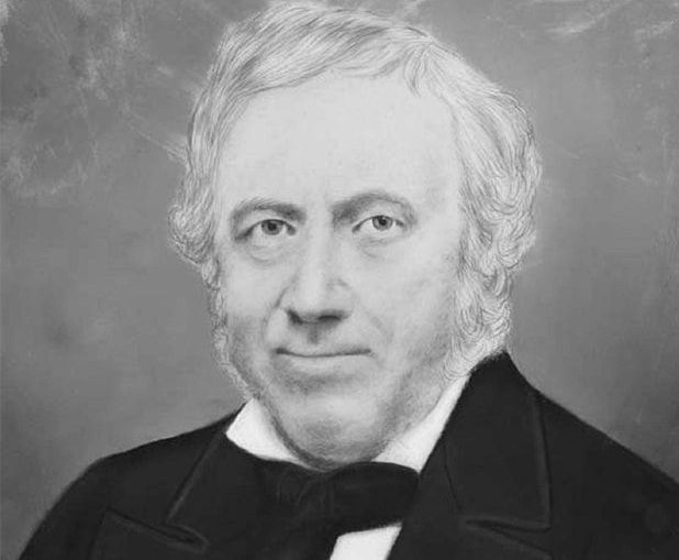 A black and white portrait of a man in a suit and tie.