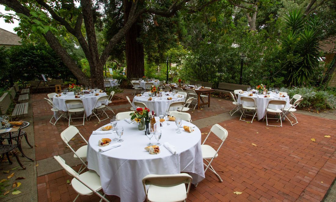A patio with tables and chairs set up for a party
