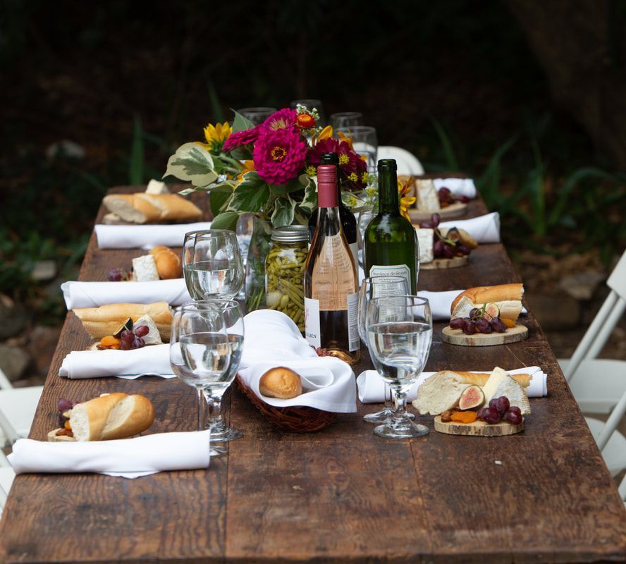 A long wooden table with a bunch of food on it