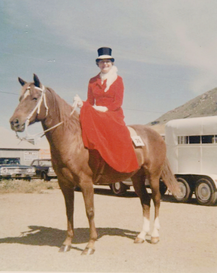 A woman in a red dress is riding a brown horse