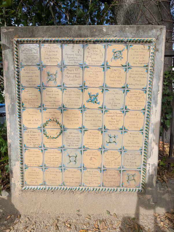 A plaque with a wreath on top of it