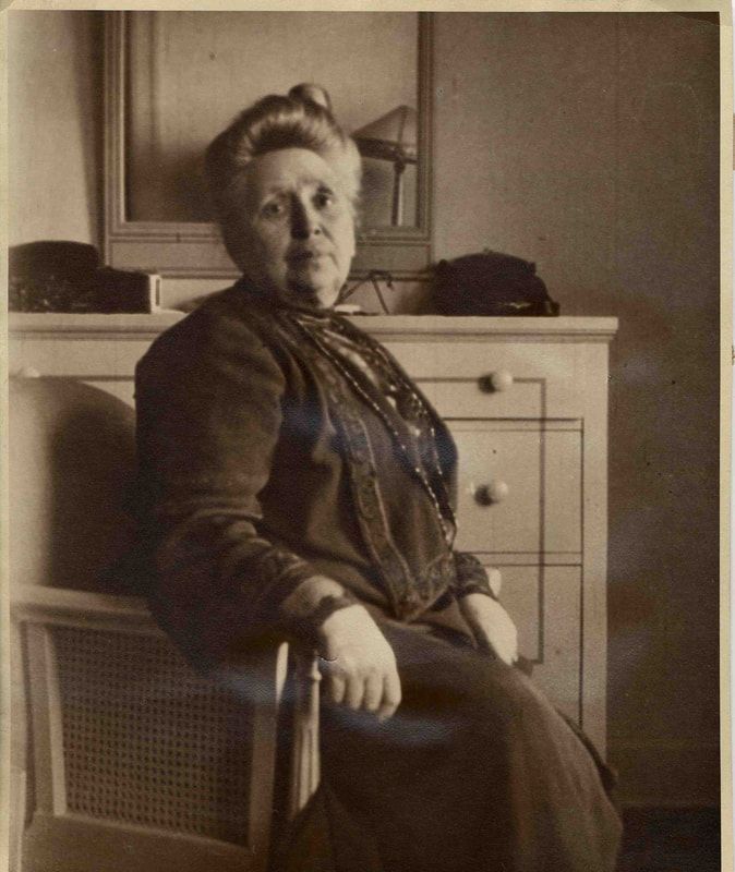 A black and white photo of a woman sitting in a chair