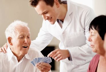 Nursing home guests enjoying a game of cards