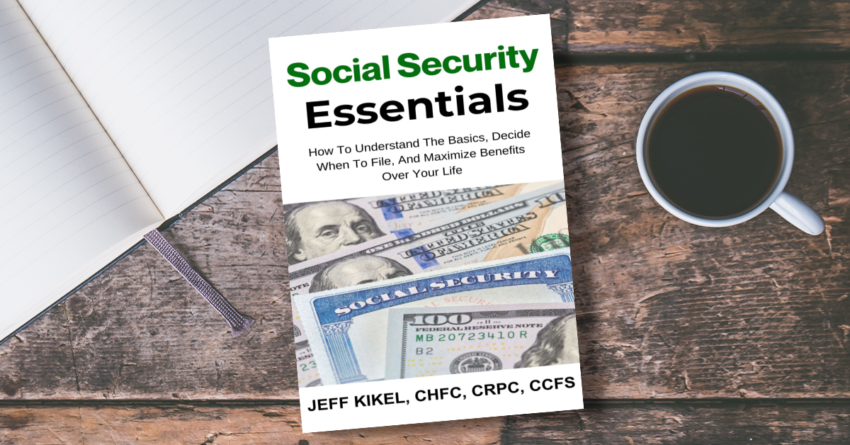 A book titled social security essentials is sitting on a wooden table next to a cup of coffee.