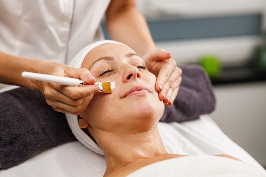 A woman is getting a facial treatment at a spa.