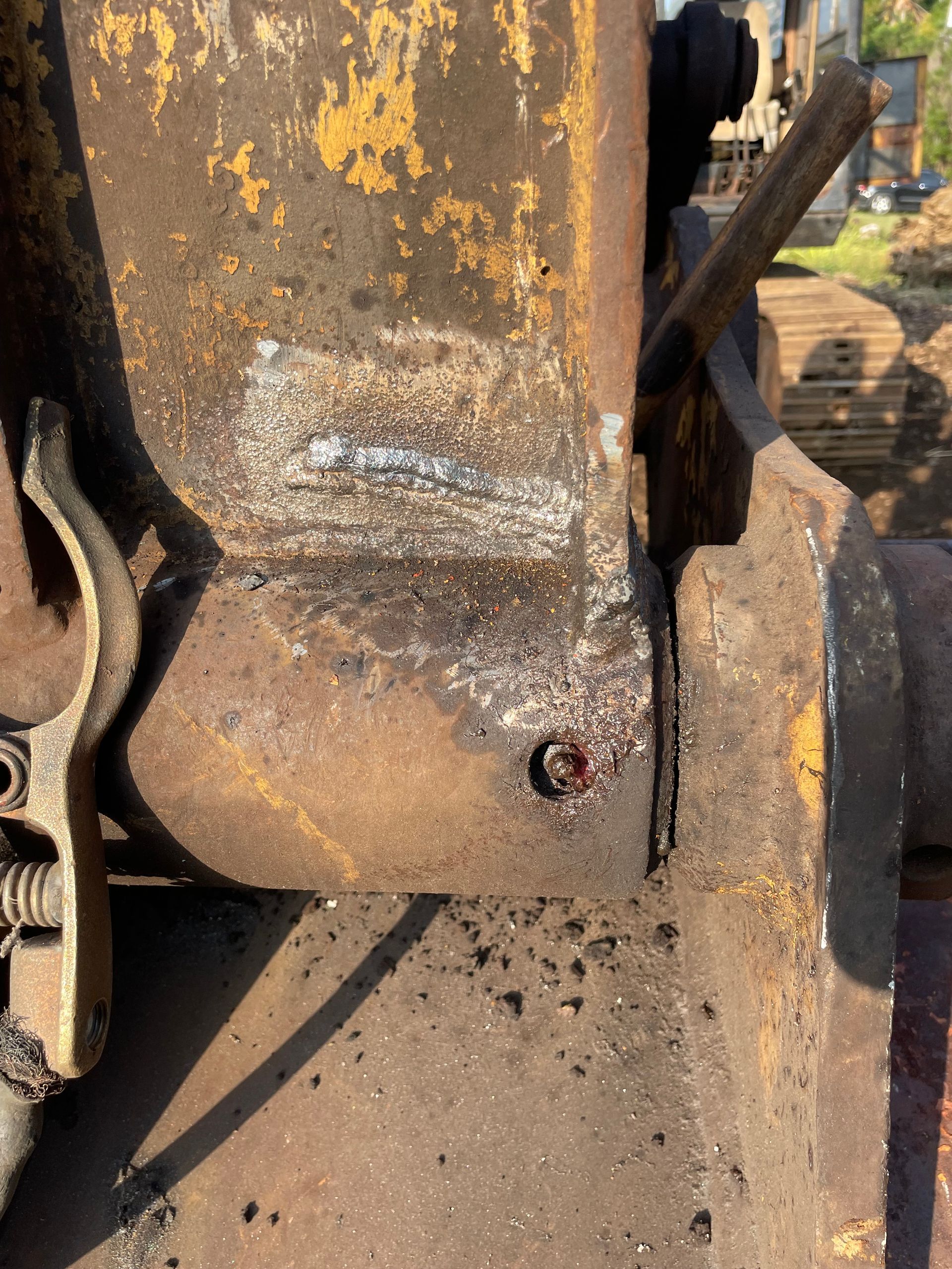 A rusty piece of metal with a screw in it