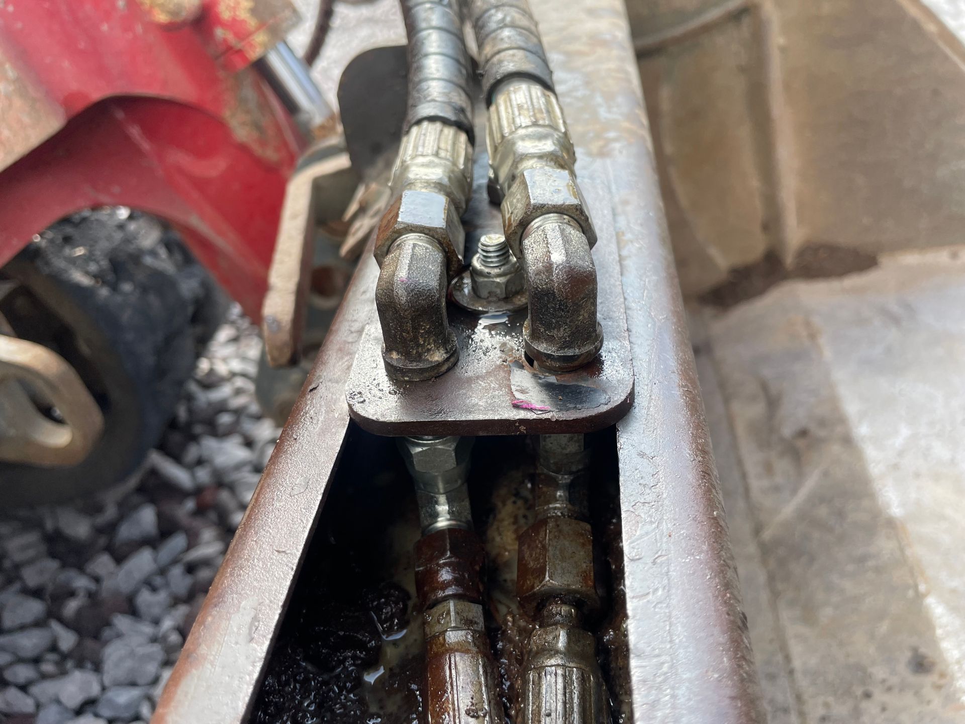 A close up of a hydraulic hose on a machine
