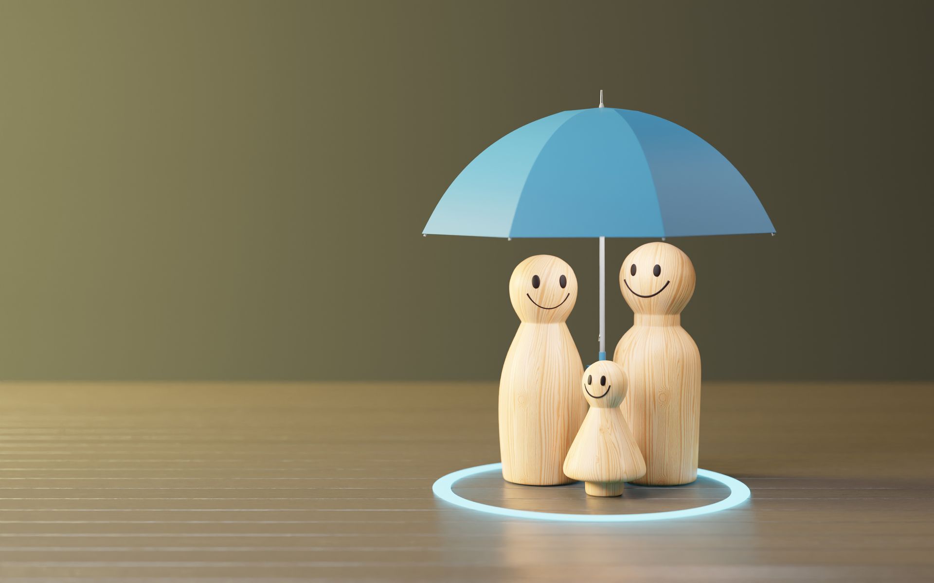 Wooden family figurines under a blue umbrella, inside a blue circle, on a wooden surface.