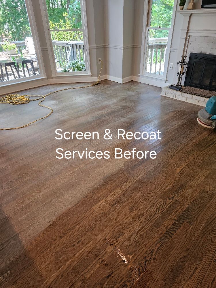 A living room with a wooden floor and a fireplace.