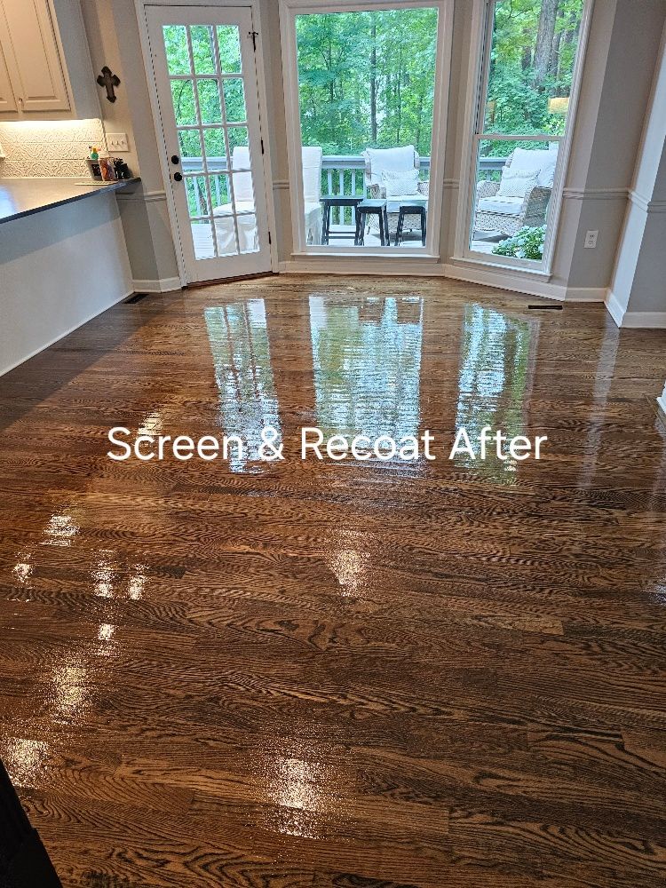 A living room with a wooden floor and a large window.