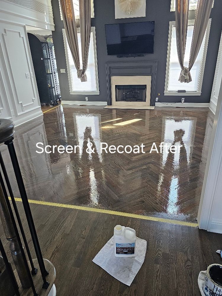 A living room with a wooden floor and a fireplace.