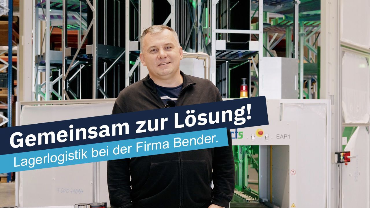 Man standing in front of warehouse machinery, text: 