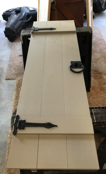 White wooden door on a carpeted floor with a black handle and latch hardware.