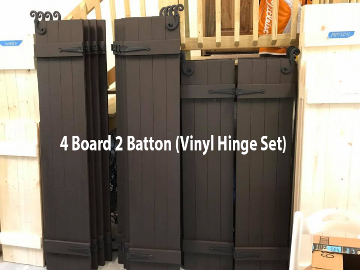 Black 4-board 2-baton vinyl fence gate set leaning upright in a yard￼