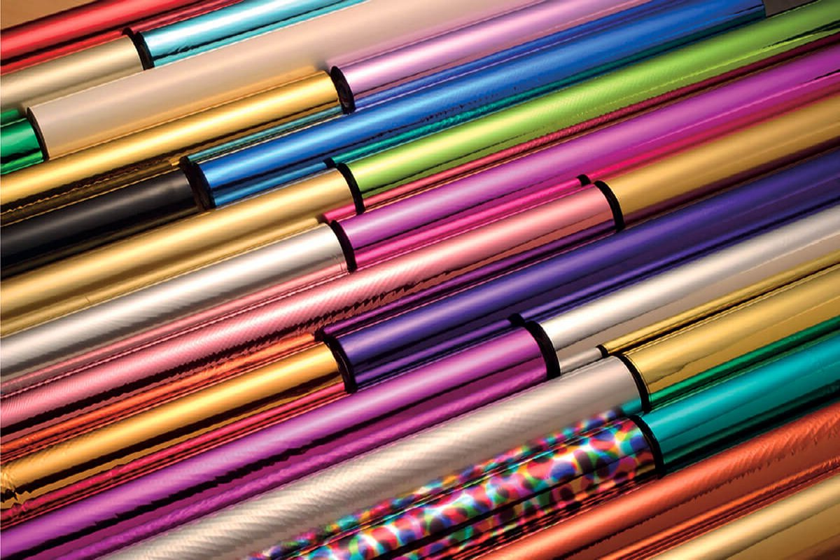 A bunch of different colored metal tubes are stacked on top of each other.