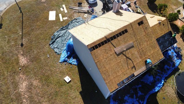 House roof beside dead grasses - Woodstock, GA | MTak Roofing Systems