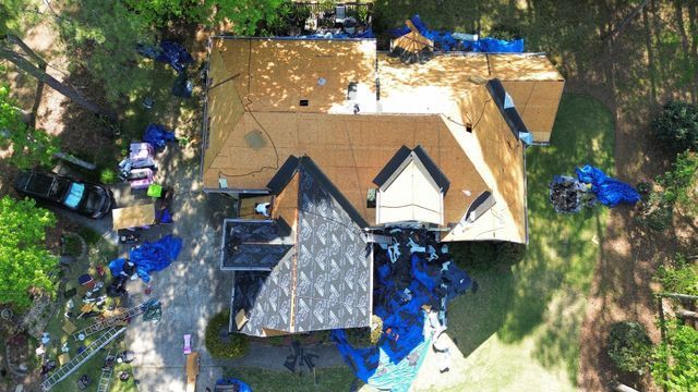 Aerial view of a house under construction with a roof being installed - Woodstock, GA | MTak Roofing Systems