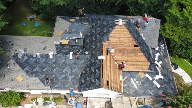 Workers installing something on the roof - Woodstock, GA | MTak Roofing Systems