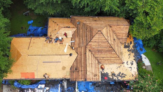 Workers renovating a house roof - Woodstock, GA | MTak Roofing Systems