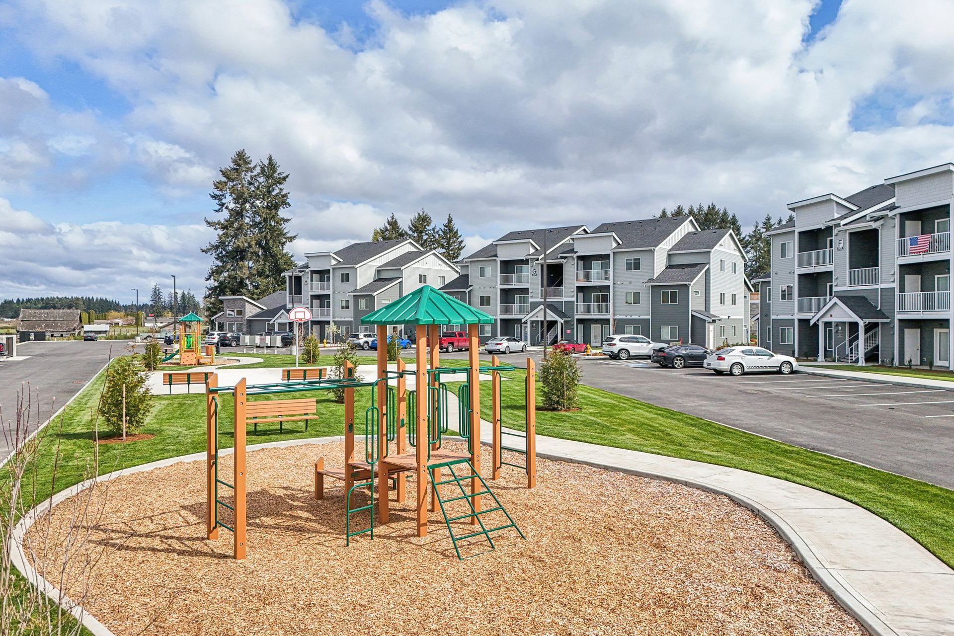 Children’s playground beside modern apartment buildings on a cloudy day
