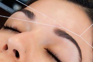 Woman having her eyebrows threaded