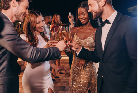 A group of people are toasting with champagne glasses at a party.