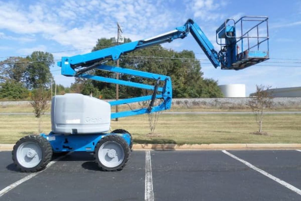 Boom lift positioned for elevated tree trimming work, worked on by Top'em & Drop'em in Geneva, FL.