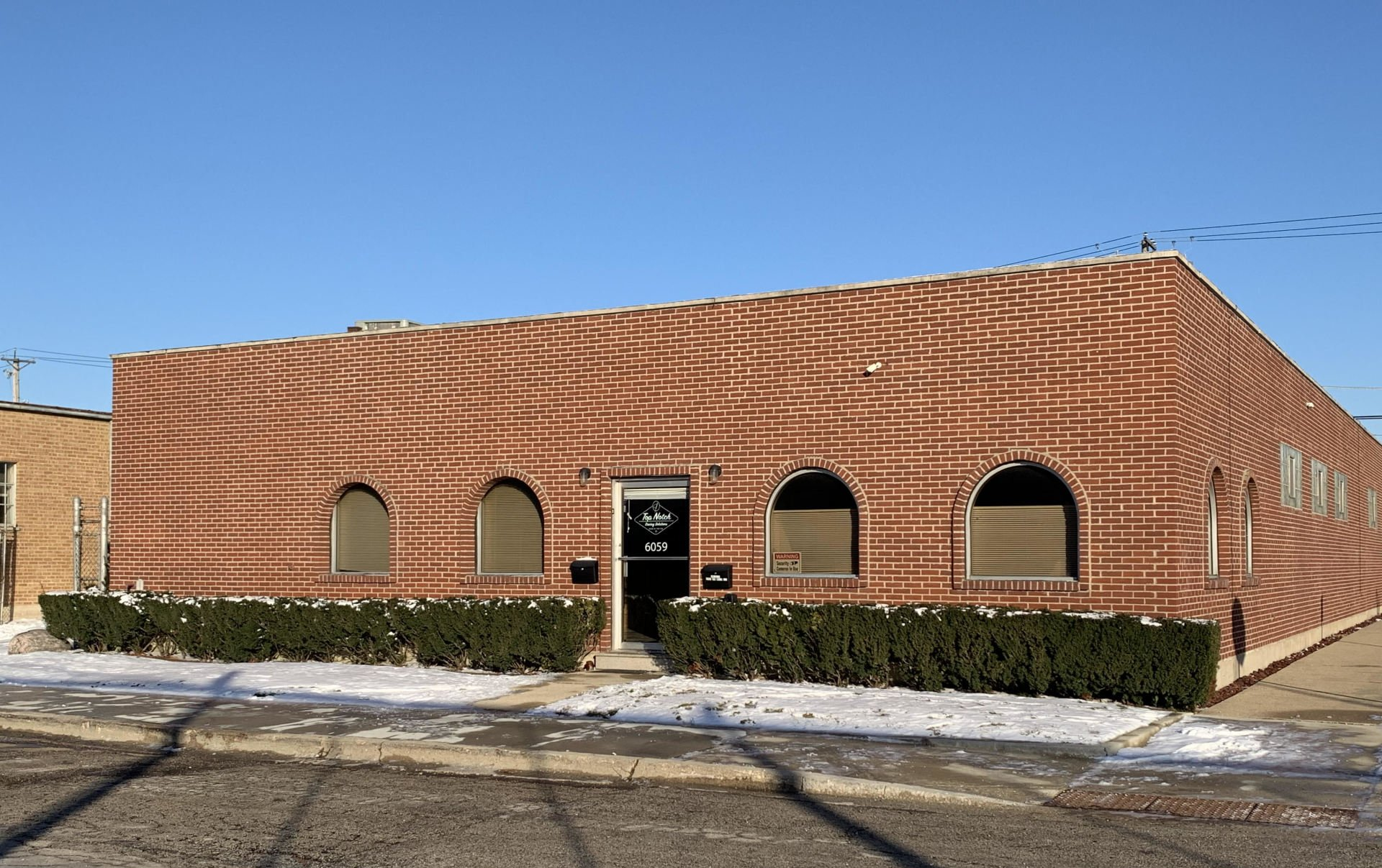 A brick building with a zebra print on the side of it.