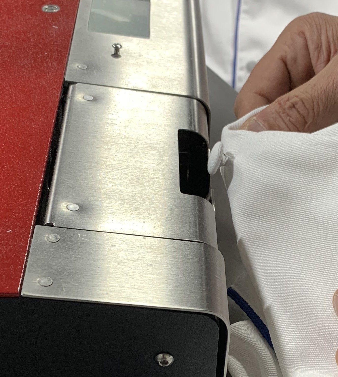 A person is using a machine to sew a shirt