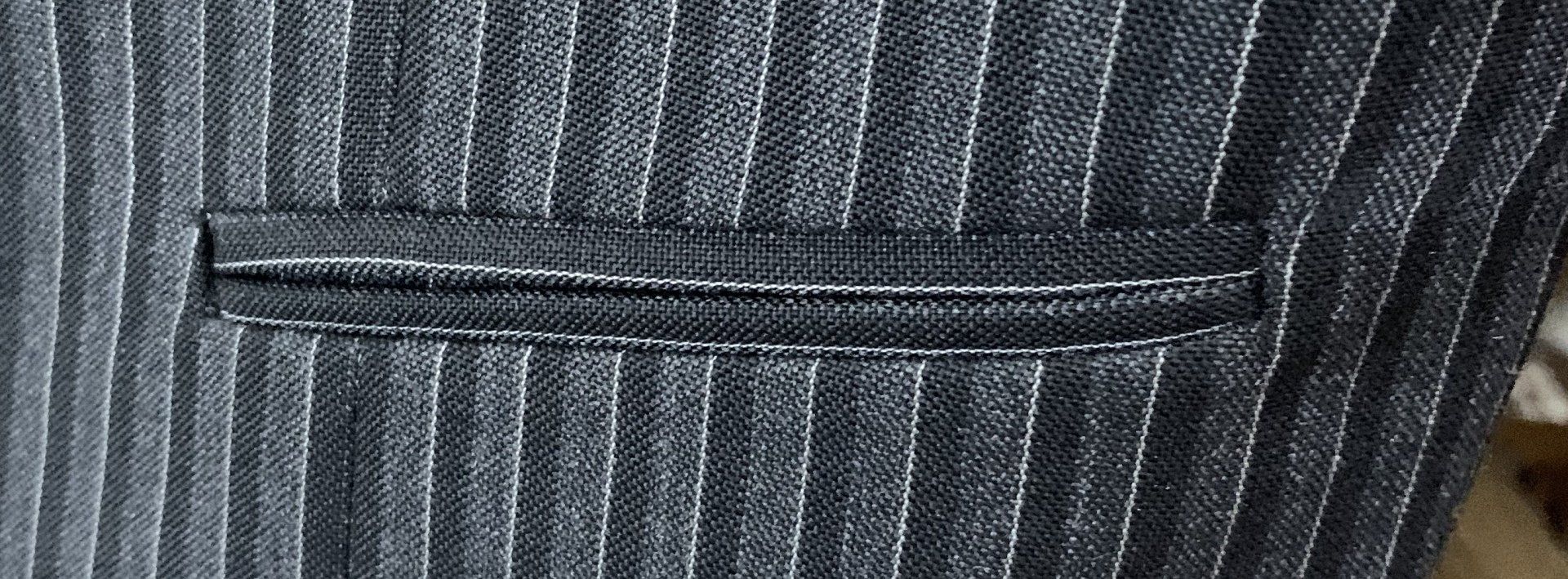 A close up of a pocket on a suit jacket.