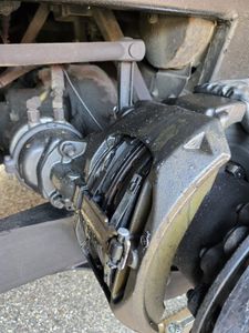 A close up of a brake caliper on a truck.