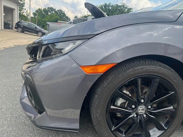 Gray Honda Civic with black wheels and orange side marker.