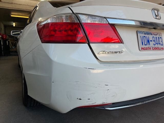 White Honda Accord with rear bumper damage; North Carolina license plate visible.