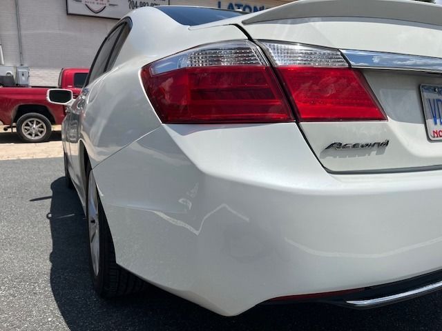 White Honda Accord rear side, taillight visible, parked on pavement, sunny day.