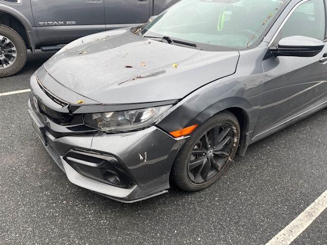 Gray Honda Civic car with damage to the front. Parked outside.