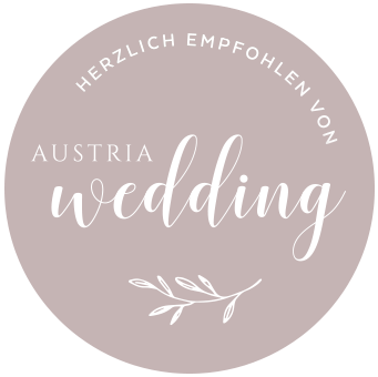 Austria Wedding logo on a beige circle with white script and “Herzlich empfohlen von” text