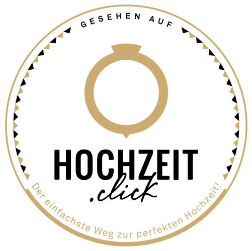 Logo für Hochzeit.click mit goldenem Verlobungsring-Symbol und deutschem Text auf weißem Hintergrund