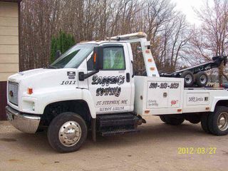 Tow truck towing a car — Peggan's Auto Body & Sandblasting, LLC in St. Stephen, MN