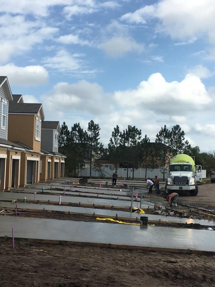 A construction site with a yellow truck in the background